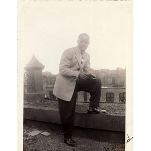 Richard Joseph poses on the roof of a building overlooking Haskins Street in Roxbury, Massachusetts