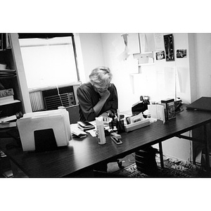 Woman reading something at her desk in her office.