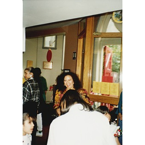 Jovita Fontanez (center) in a lobby crowded with children and young people.