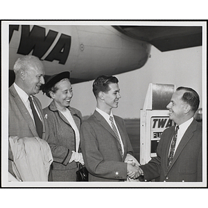 Richard J. O'Neil shakes hands with Paul F. Hellmuth, President of the Boys' Clubs of Boston, while Arthur and Barbara Burger look on