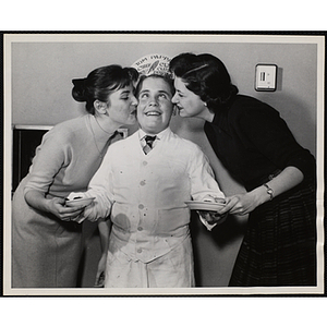 A member of the Tom Pappas Chefs' Club receives thanks from two women for serving desserts at Brandeis University