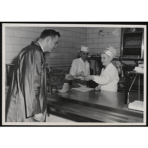 A member of the Tom Pappas Chefs' Club serves a diner at the Hanscom Field Air Force Base restaurant