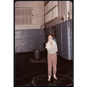 A girl puts on a Charlestown t-shirt at the Charlestown gymnasium