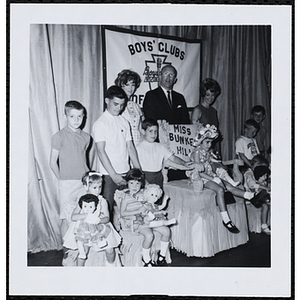 Group portrait of the Little Sister Contest winners with their brothers and three judges, including Charles H. Hood, at center