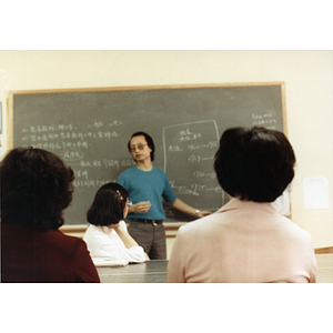 Teacher of a job placement class stands at a chalkboard