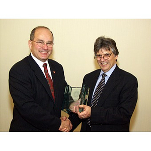 Dr. Ira R. Weiss, right, presents Robert DiCenso, CBA '62, with the College of Business Administration's Distinguished Service Award