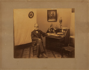 Full-length portrait of Henry Fowler, seated on a chair, facing front, Rae-Putnam Fowler House, Danvers, Mass., undated