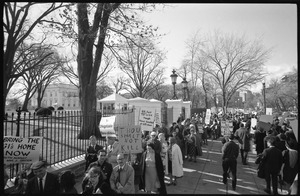Protesters outside the White House marching against the war in Vietnam, carrying signs reading 'Thou shalt not kill;' 'US said no in '64 though Hanoi knocked at UN door;' and 'Vietnam no, freedom yes, LBJ stop now': Washington Vietnam March for Peace