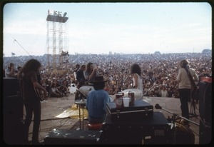 Jefferson Airplane performing at the Woodstock Festival, view from rear stage overlooking the audience