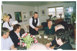 Sidney Lipshires (center) receiving a cake at a party
