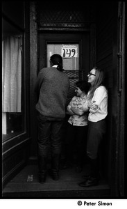 Three people entering the door at 149 Columbia Street, Cambridge