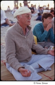 Ram Dass posing in half lotus on the beach