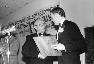 Mayor Raymond L. Flynn receiving the Outstanding Citizen Award from Massachusetts Speaker of the House Thomas McGee at the 1984 Evacuation Day Banquet with State Representative Michael Flaherty and Senate President William M. Bulger