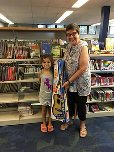Skye receives the Summer Reading Grand Prize from Children's Librarian Ellen Nickerson