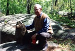 Frederick Wilkins posing in a wooded area at the Wilkins family home