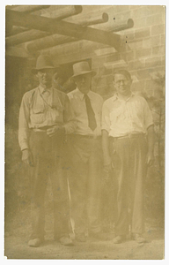 Cary C. Marshall with two other men in front of the Pueblo of the Seven Fires