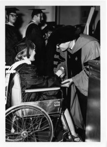 Student in a wheelchair receives her degree at the 1969 Suffolk University commencement