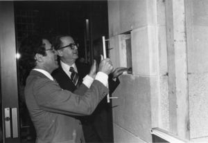 Suffolk University President Daniel H. Perlman (1980-1989) and Trustee Harry Zohn open a time capsule on Founder's day during the university's 75th Anniversary celebrations