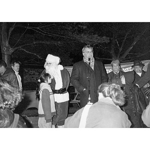 Mayor Menino addresses Villa Victoria residents on a night near Christmas.