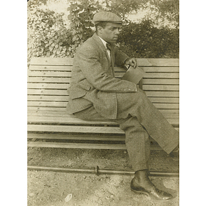 Charles H. Bruce sitting on bench