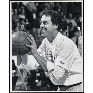 Former Boston Celtic Dave Cowens holding a basketball and standing in shooting position at a fund-raising event held by the Boys and Girls Clubs of Boston and Boston Celtics