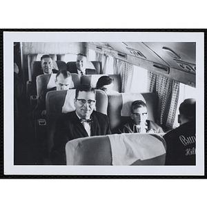 Passengers sit in an airplane cabin, including Boys and Girls Clubs of Boston Executive Director William J. Lynch (third row, right)