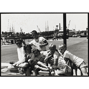 A Group of children sitting with their counselor at the Charlestown Navy Yard pier