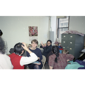 Women and children sitting in the Chinese Progressive Association office during a celebration of the Chinese New Year