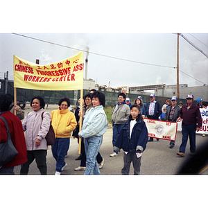 Women from the Chinese Progressive Association Workers' Center carrying a banner in the International Paper Company strike