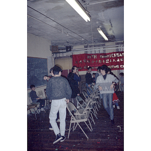 Chinese Progressive Association members playing musical chairs at a celebration for the Garment Workers' Center