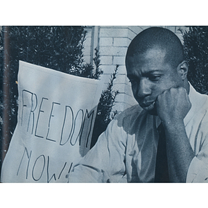 Young African American man with "Freedom Now" sign