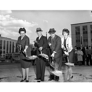 Four people with shovels at the groundbreaking ceremony for Speare Hall