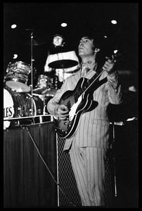 John Lennon (the Beatles) playing guitar in concert at D.C. Stadium