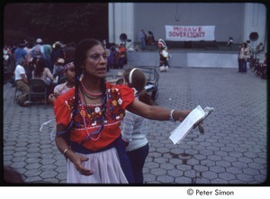 MUSE concert and rally: woman at Mohawk sovereignty rally holding money