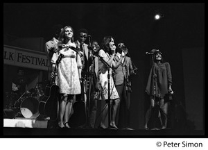 Judy Collins, Joan Baez, Mimi Farina (l. to r.) and the Chambers Brothers (rear) at the Newport Folk Festival