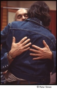 Ram Dass embracing a man after a lecture at Boston University