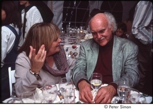 Ram Dass at a table with an unidentified woman