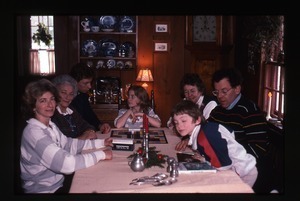 Dan Keller, Nina Keller, and family playing Pictionary at Christmas table