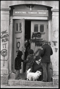 Women's occupation of the Architectural Technology Workshop, Harvard University: occupiers at door greeting children, dog