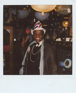 A Photograph of Marsha P. Johnson Wearing a USA Flag Hat and Formalwear