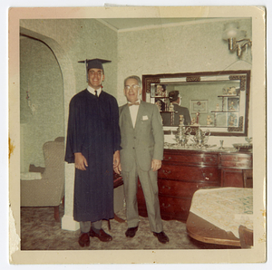 Robert Mello, in graduation gown, with his father