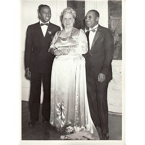 Two men pose with a woman