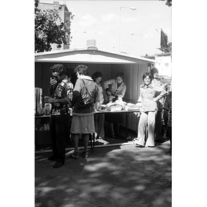 People at food vending stand at a Latino street festival
