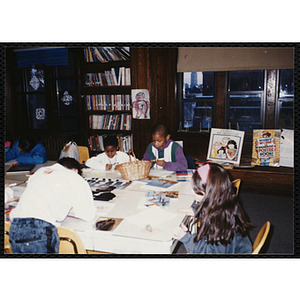 Several Boys and Girls Club members working on a project in a classroom