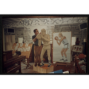 A photograph of a New England Sports Museum diorama in which a sculptor in his studio renders a statue of the Boston Celtics' Larry Bird