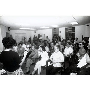 Woman addresses a group of Association members