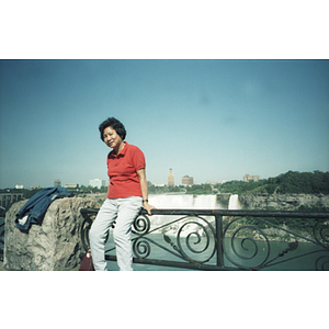 Chinese Progressive Association member sits on a wall overlooking Niagara Falls