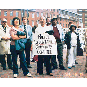 Demontrator holds up sign that reads, "Police Accountability, Community Control"