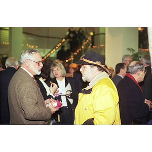 Two men converse at the inauguration of President Freeland