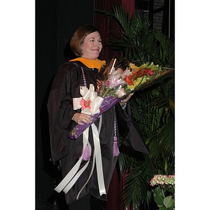 Student holding flowers at School of Nursing convocation